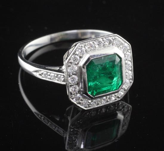 A platinum, emerald and diamond cluster ring, size P.